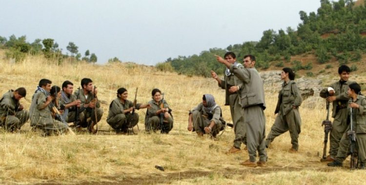 Guerrilla fighters of the PKK (Kurdistan Worker's Party) listen to instructions from their team commander during a training session in a camp near Arbil in the Haqourqi mountains, northern Iraq, 11 August 2005. The PKK, which has stepped up violence in Turkey's mainly Kurdish southeast over the past few months, retreated to northern Iraq after a unilateral ceasefire it declared in 1999 in its war with Ankara. The militants began sneaking back after they called off the truce in June 2004. The Kurdish conflict in Turkey has claimed some 37,000 lives since 1984 when the PKK took up arms for Kurdish self-rule in the country's southeast.    AFP PHOTO/Mustafa Ozer